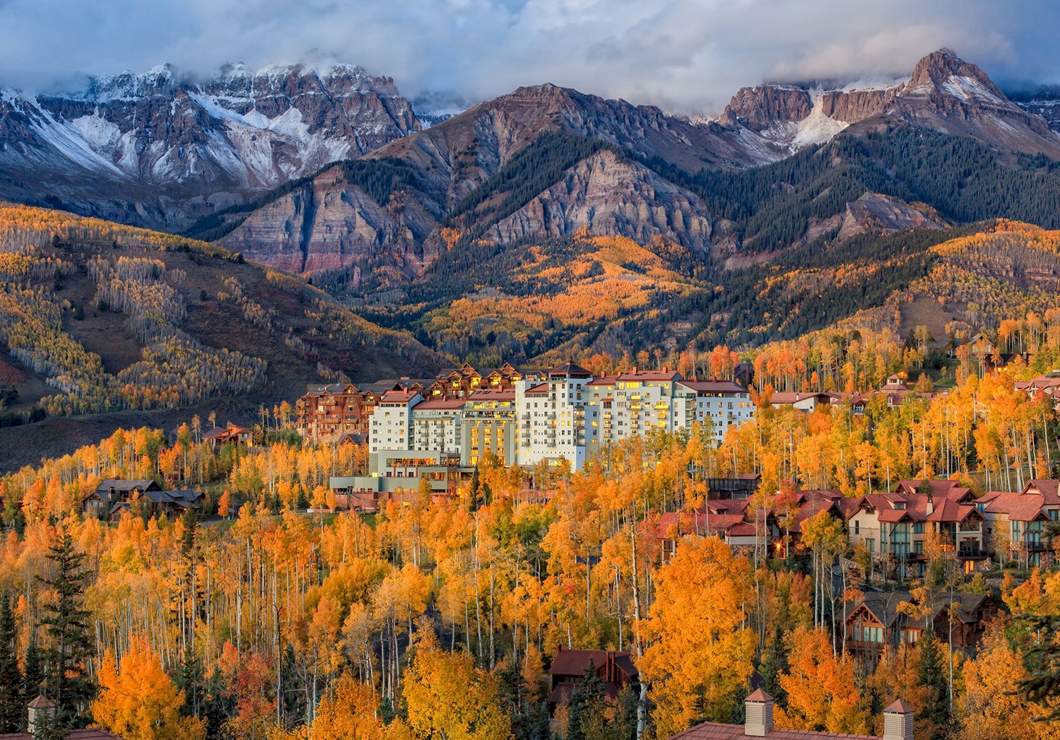 The Peaks Hotel in the fall with mountains in the background